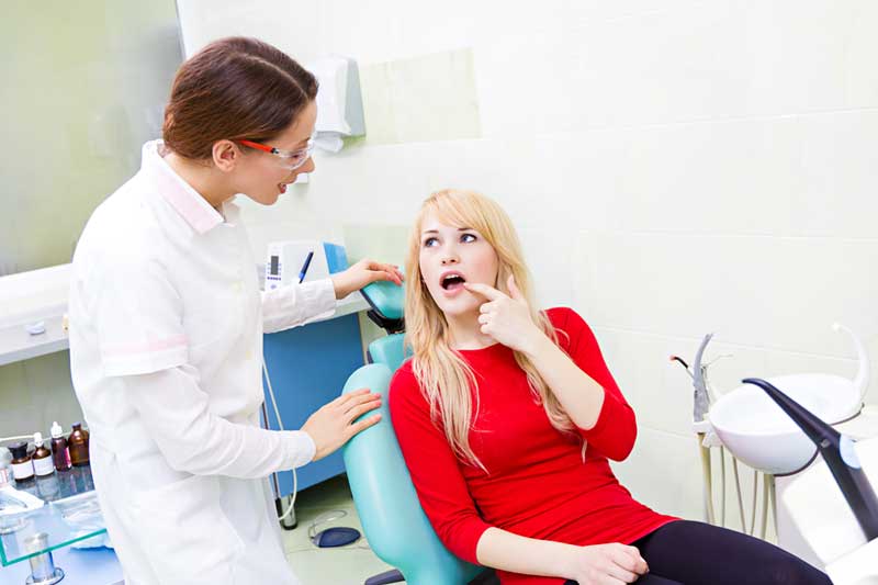 Patient Showing Her Painful Mouth to Doctor